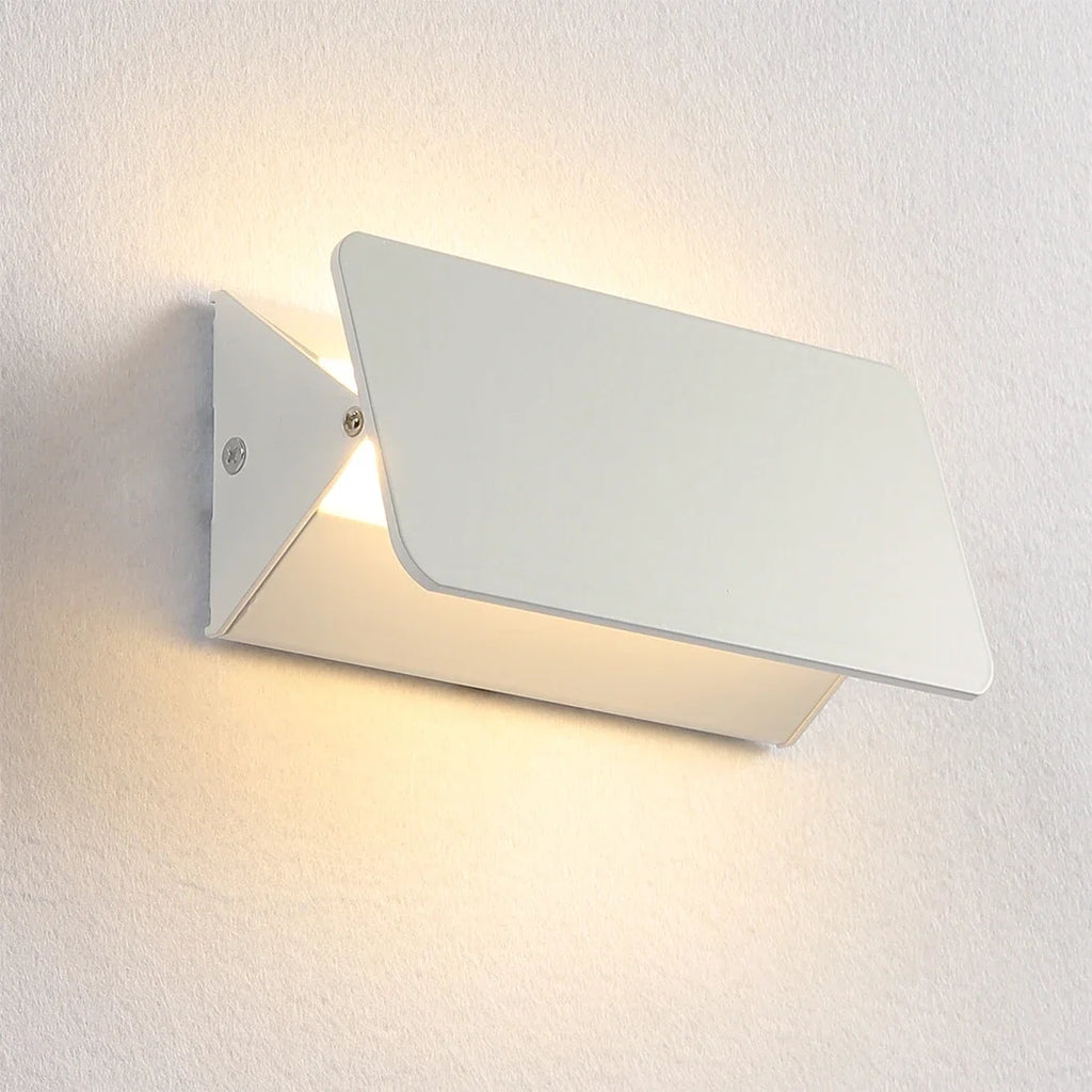 Adjustable angle aluminium LED wall lamp mounted beside a vanity mirror