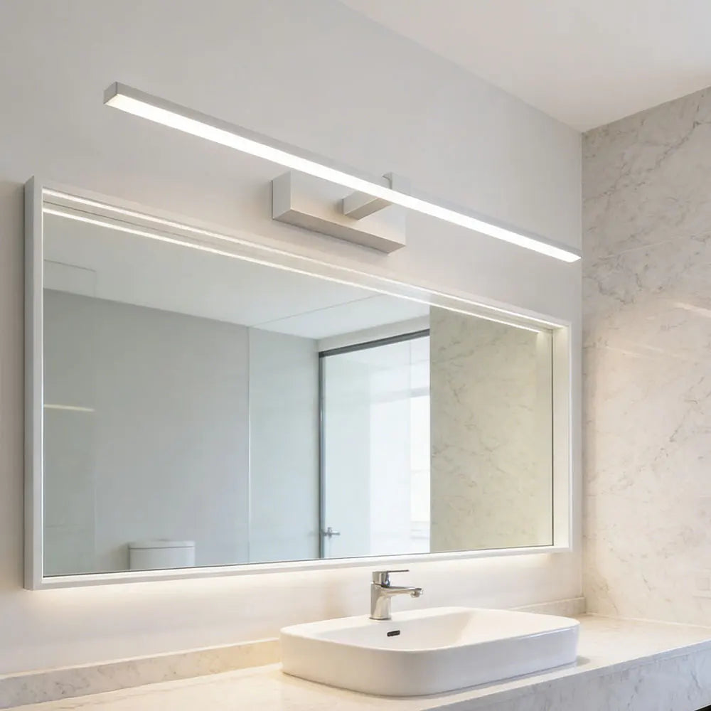 Modern LED vanity mirror wall light illuminating a bathroom mirror