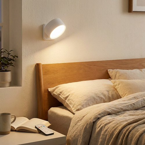 Magnetic wall sconce with remote mounted on a bedroom wall glowing softly
